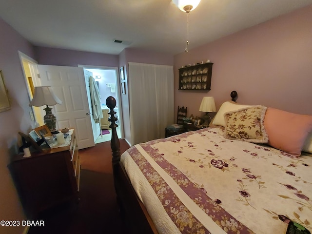 carpeted bedroom featuring ensuite bath