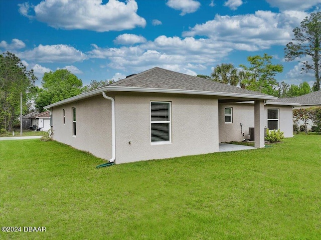 rear view of property featuring a yard and a patio