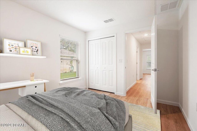 bedroom with hardwood / wood-style flooring and a closet