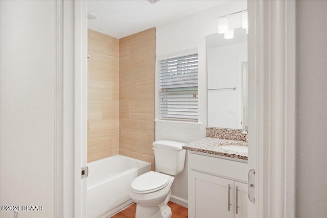 full bathroom with vanity, hardwood / wood-style flooring, tiled shower / bath combo, and toilet