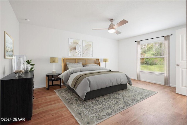 bedroom with light hardwood / wood-style floors and ceiling fan