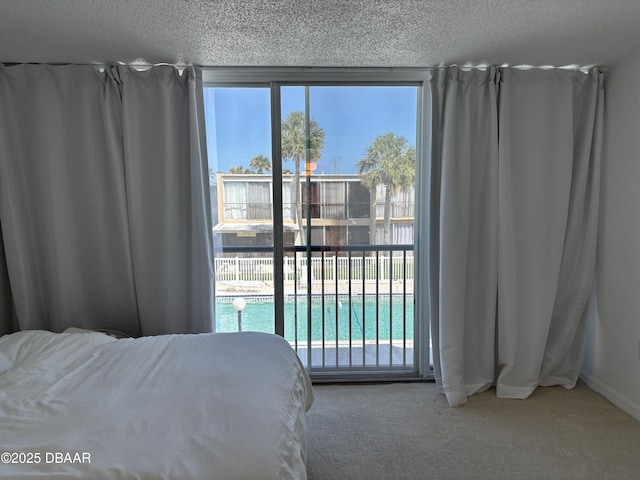 5500 Ocean Shore Blvd Unit 18, Ormond Beach, FL 32176 - carpeted bedroom featuring a textured ceiling