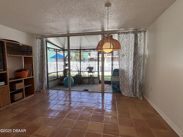 5500 Ocean Shore Blvd Unit 18, Ormond Beach, FL 32176 - unfurnished dining area with tile patterned floors, baseboards, and a textured ceiling
