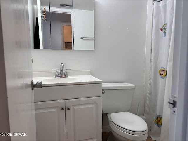 5500 Ocean Shore Blvd Unit 18, Ormond Beach, FL 32176 - bathroom featuring a shower with shower curtain, vanity, visible vents, and toilet