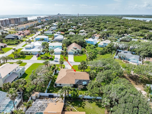drone / aerial view with a water view and a residential view