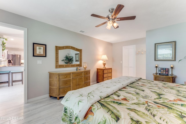 64 Alberta Ave, Ponce Inlet, FL 32127 - bedroom with stainless steel fridge with ice dispenser, light wood finished floors, baseboards, and a ceiling fan