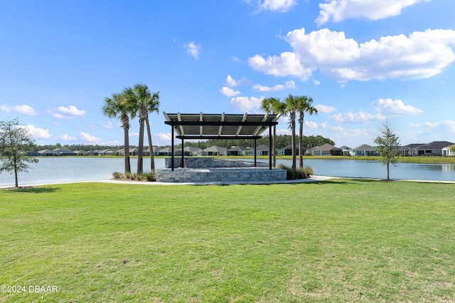 dock area featuring a water view and a lawn