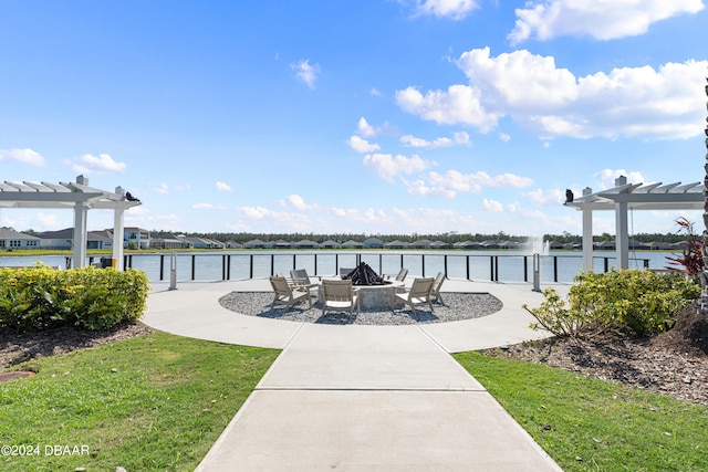 exterior space featuring a water view, a pergola, and a yard