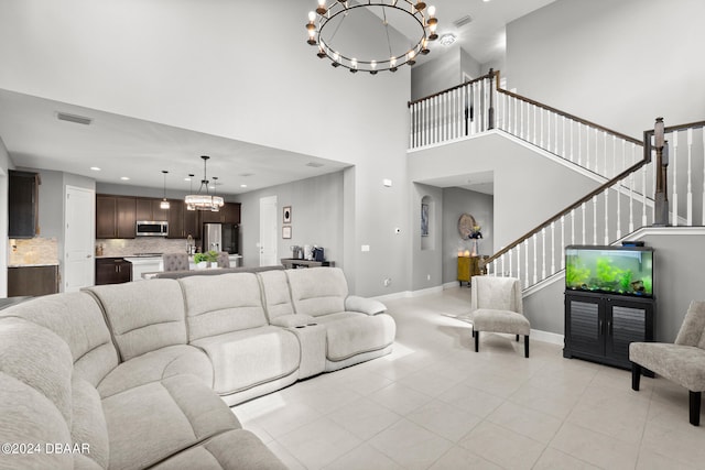 living room with a high ceiling and an inviting chandelier