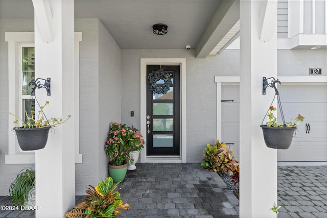 137 Azure Mist Way, Daytona Beach, FL 32124 - property entrance featuring stucco siding and a garage