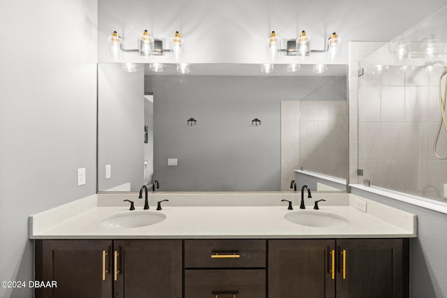 bathroom with vanity and a tile shower