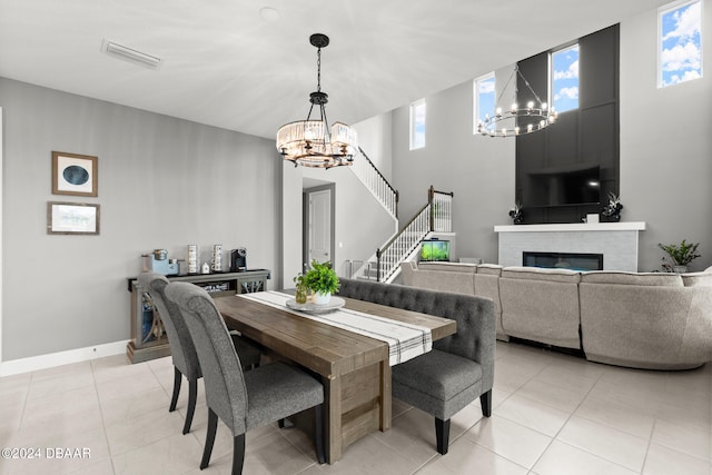 tiled dining area featuring a chandelier