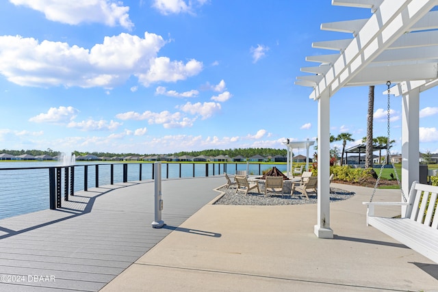 exterior space with a water view and a pergola