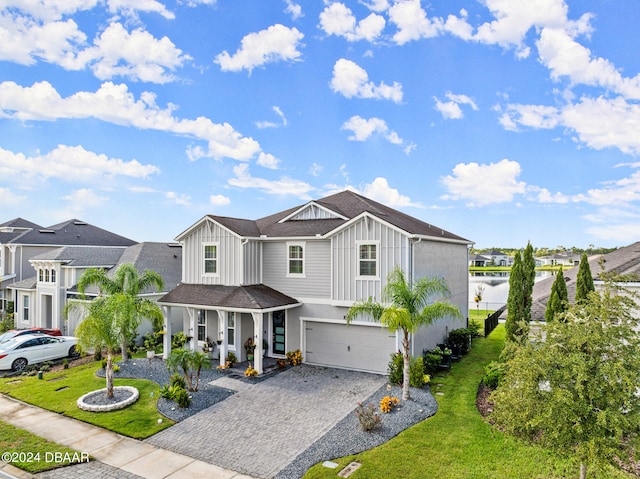 view of front of property with a garage and a front yard