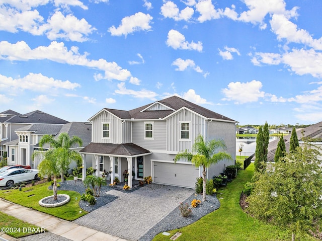 137 Azure Mist Way, Daytona Beach, FL 32124 - view of front facade with a garage, covered porch, board and batten siding, and decorative driveway