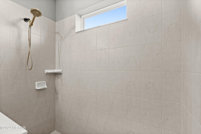 bathroom with tiled shower