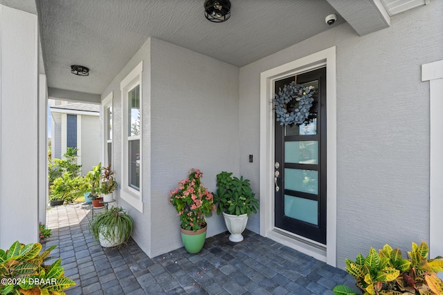 137 Azure Mist Way, Daytona Beach, FL 32124 - property entrance with stucco siding and a porch