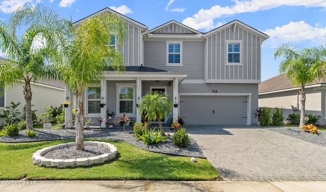 view of front of house with a garage and a front yard