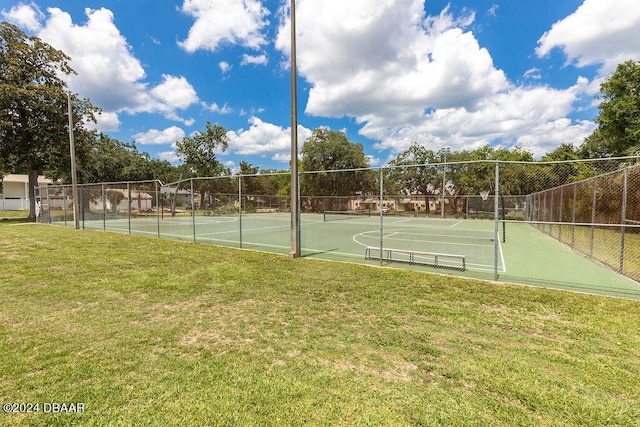 view of basketball court with tennis court and a yard