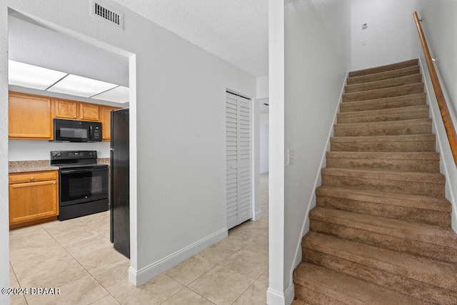 stairs with tile patterned floors