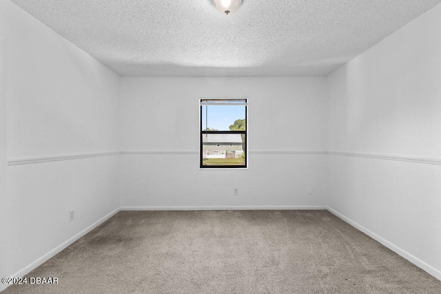 spare room with carpet floors and a textured ceiling