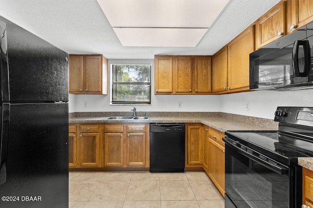 kitchen with light tile patterned floors, sink, and black appliances