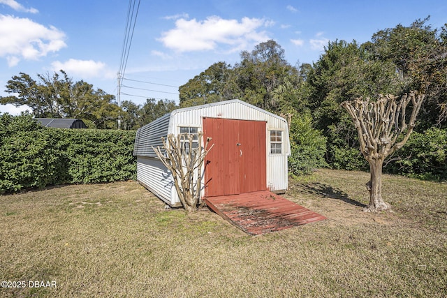 view of outdoor structure featuring a lawn