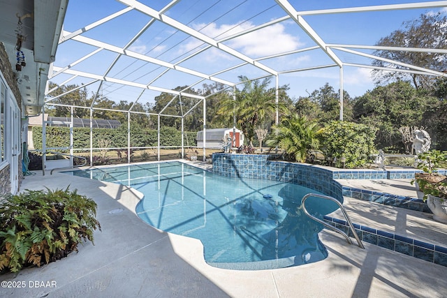 view of pool featuring a patio area and glass enclosure