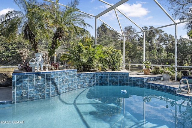 view of swimming pool featuring glass enclosure