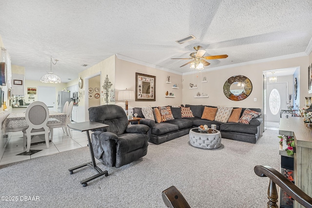 carpeted living room featuring ceiling fan, ornamental molding, and a textured ceiling