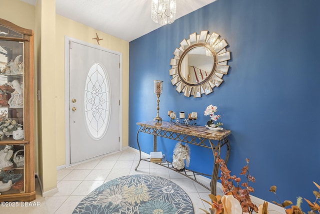 tiled entrance foyer with an inviting chandelier