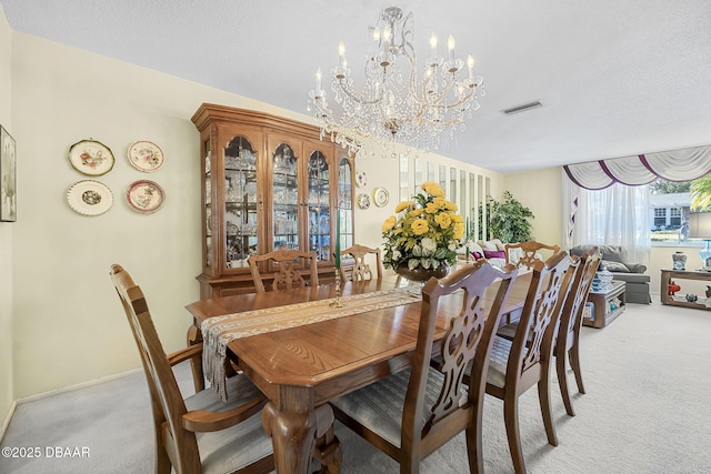 carpeted dining space featuring a textured ceiling and a chandelier