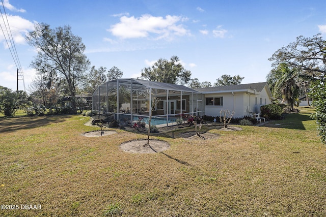 rear view of property with a lanai and a lawn