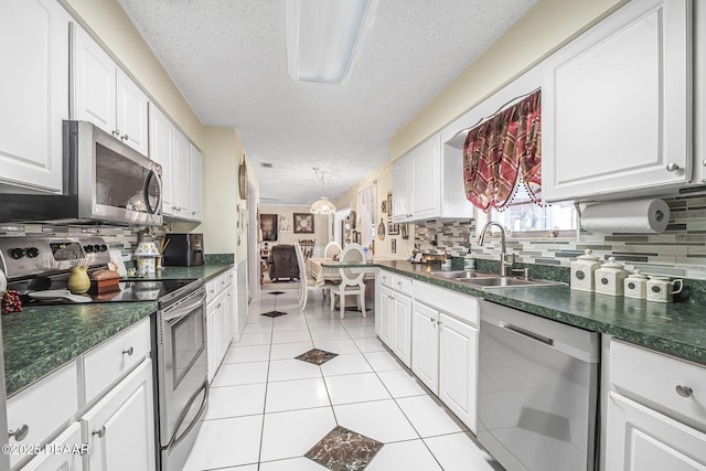 kitchen featuring appliances with stainless steel finishes, sink, and white cabinets