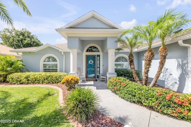 406 Phillips Creek Ln, New Smyrna Beach, FL 32168 - entrance to property with stucco siding and a yard