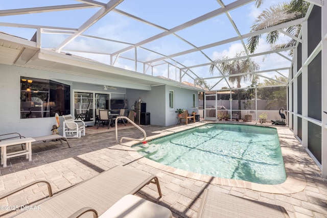 406 Phillips Creek Ln, New Smyrna Beach, FL 32168 - view of swimming pool featuring a patio area, a ceiling fan, and glass enclosure