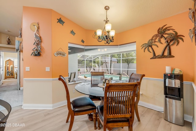 406 Phillips Creek Ln, New Smyrna Beach, FL 32168 - dining space featuring wood finished floors and a chandelier