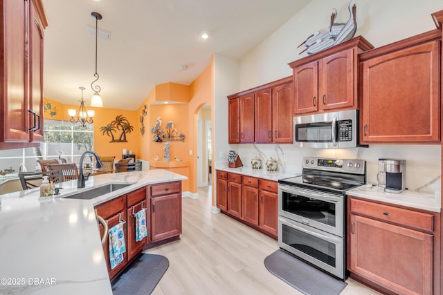 406 Phillips Creek Ln, New Smyrna Beach, FL 32168 - kitchen featuring stainless steel appliances, arched walkways, lofted ceiling, a chandelier, and pendant lighting
