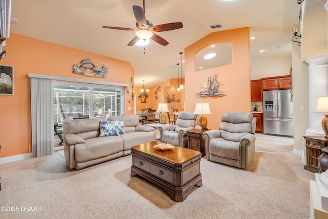 406 Phillips Creek Ln, New Smyrna Beach, FL 32168 - living room with high vaulted ceiling, light carpet, a ceiling fan, and a chandelier