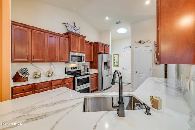 406 Phillips Creek Ln, New Smyrna Beach, FL 32168 - kitchen with appliances with stainless steel finishes, light stone countertops, and lofted ceiling