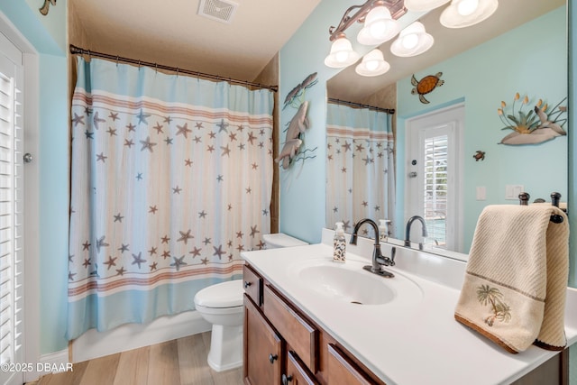 406 Phillips Creek Ln, New Smyrna Beach, FL 32168 - bathroom with vanity, wood finished floors, a chandelier, and shower / bath combo