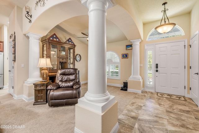 406 Phillips Creek Ln, New Smyrna Beach, FL 32168 - foyer entrance featuring ornate columns, arched walkways, a ceiling fan, light carpet, and lofted ceiling