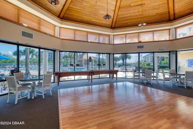 interior space with beam ceiling, hardwood / wood-style flooring, high vaulted ceiling, and wooden ceiling