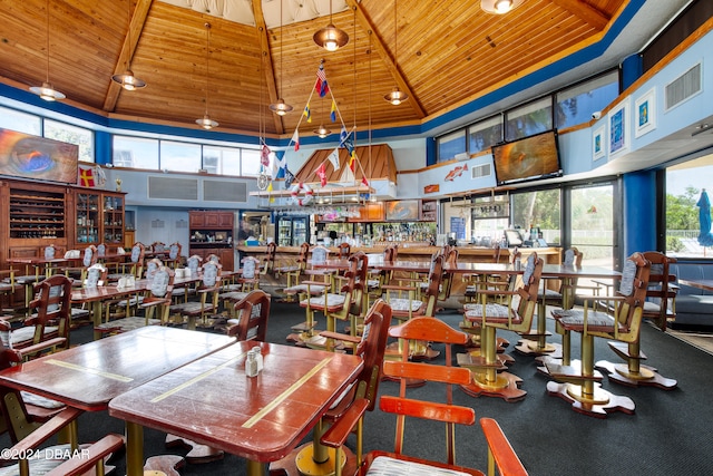 dining area featuring wood ceiling and high vaulted ceiling