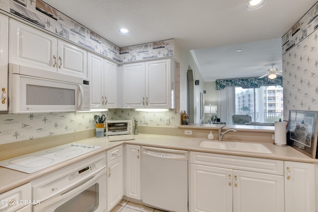 kitchen with white appliances, ceiling fan, sink, light tile patterned floors, and white cabinets