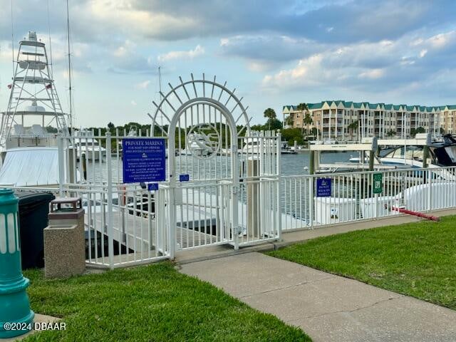 view of gate featuring a yard and a water view