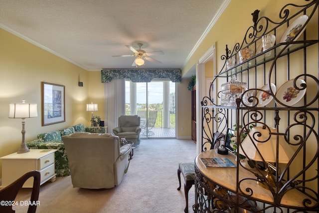 carpeted living room with a textured ceiling, ceiling fan, and ornamental molding