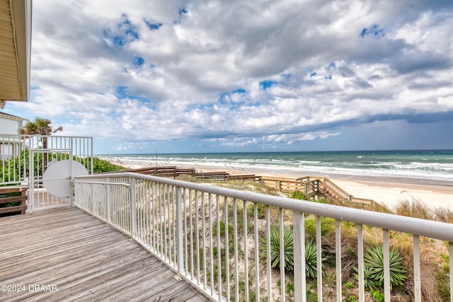 deck with a water view and a beach view