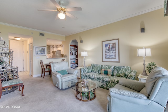 living room with crown molding, ceiling fan, and light colored carpet