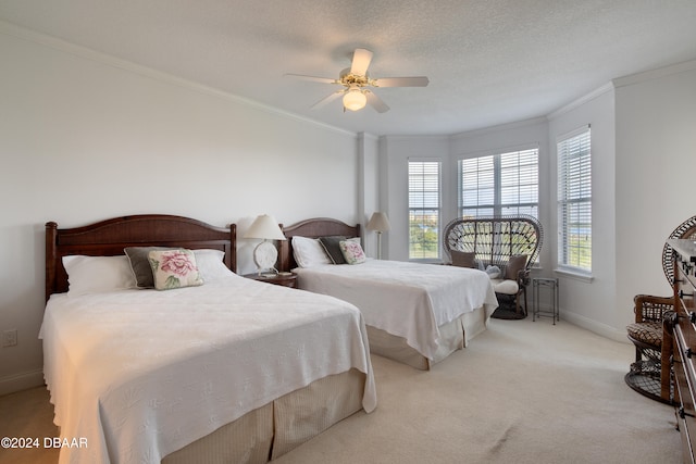 carpeted bedroom with ceiling fan, ornamental molding, and a textured ceiling